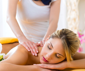 Massage Therapy being applied to a woman lying down